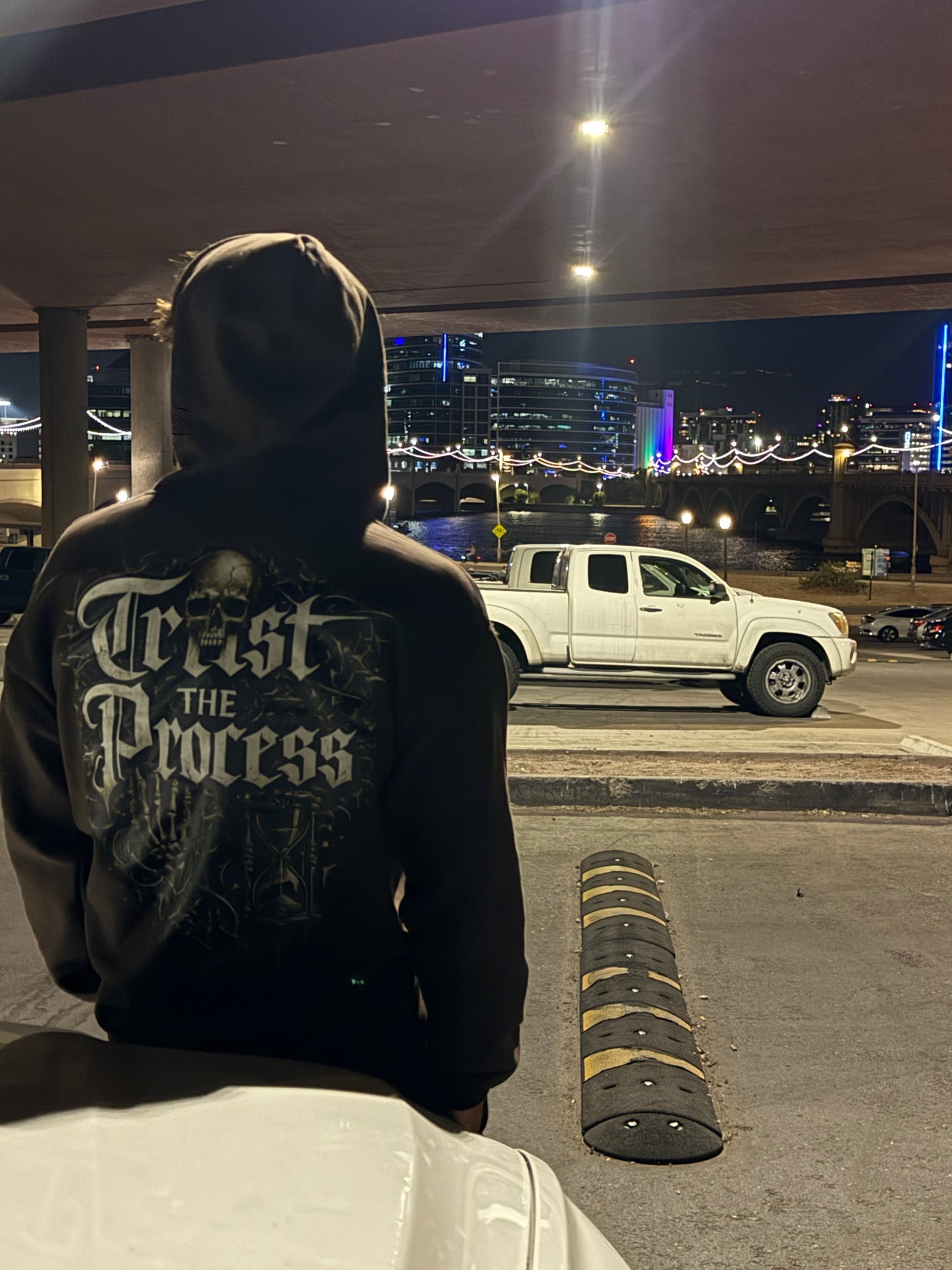 IVN Atelier Trust The Process fleece zip-up hoodie shown in gray with front pockets and a drawstring hood.