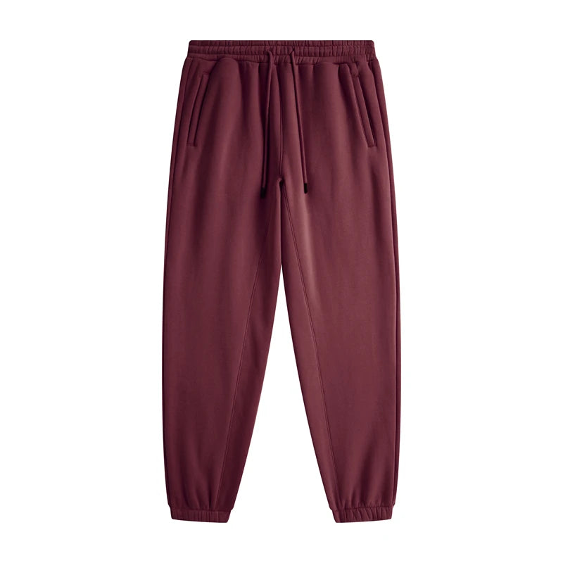 IVN Atelier solid color loose sweatpants with relaxed fit and elastic waistband, shown in a neutral fabric and casual style.