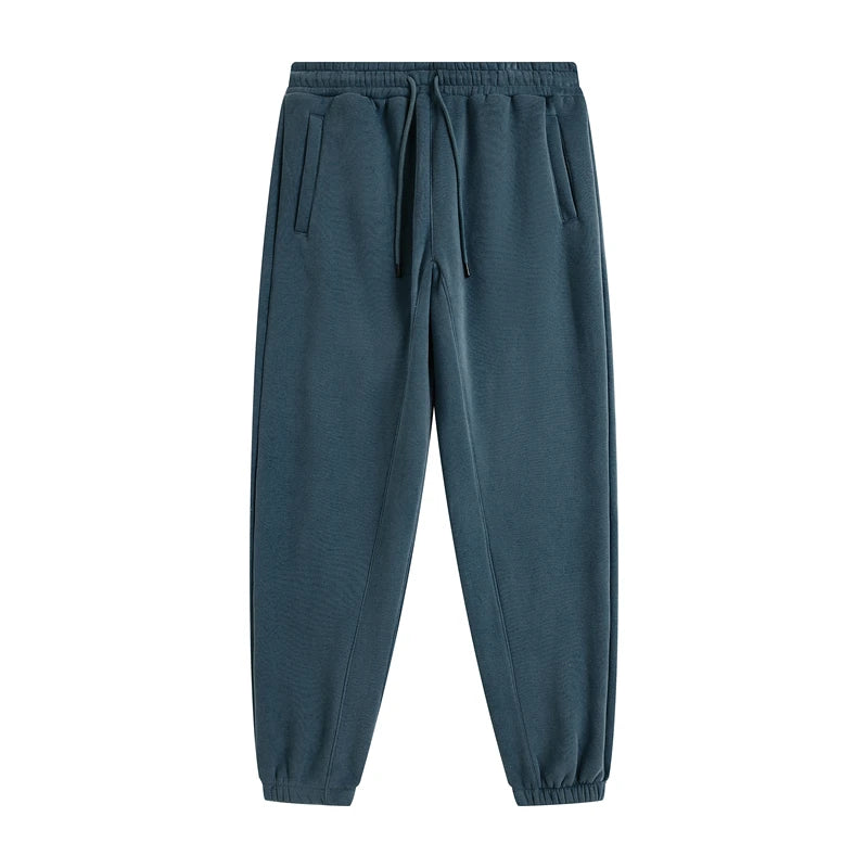 IVN Atelier solid color loose sweatpants, comfortable relaxed fit, soft fabric, shown in a natural pose against a neutral background.